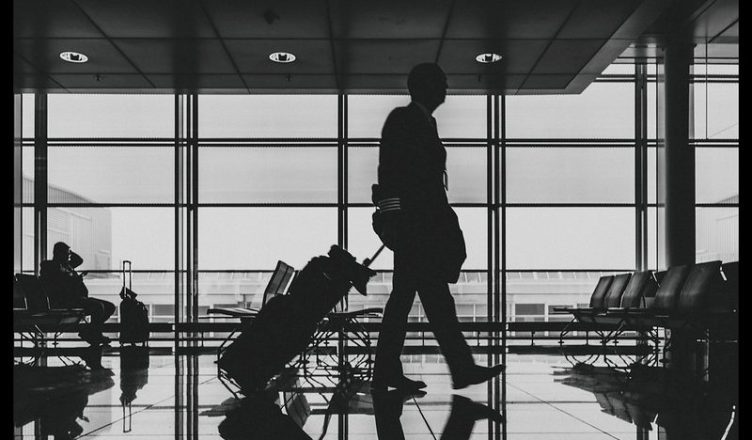 A man with his baggage at airport.