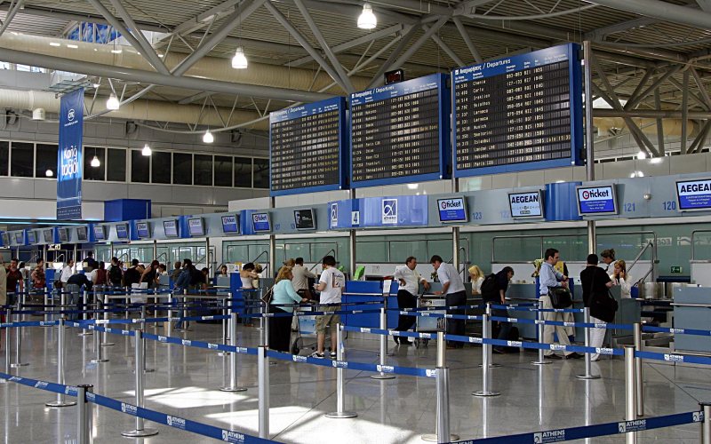 Passengers having their passport check at at Athens Airport.