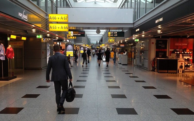 A man walking with a black color bag at Dusseldorf Airport