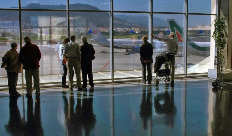 A group of people standing at Spain Airport.