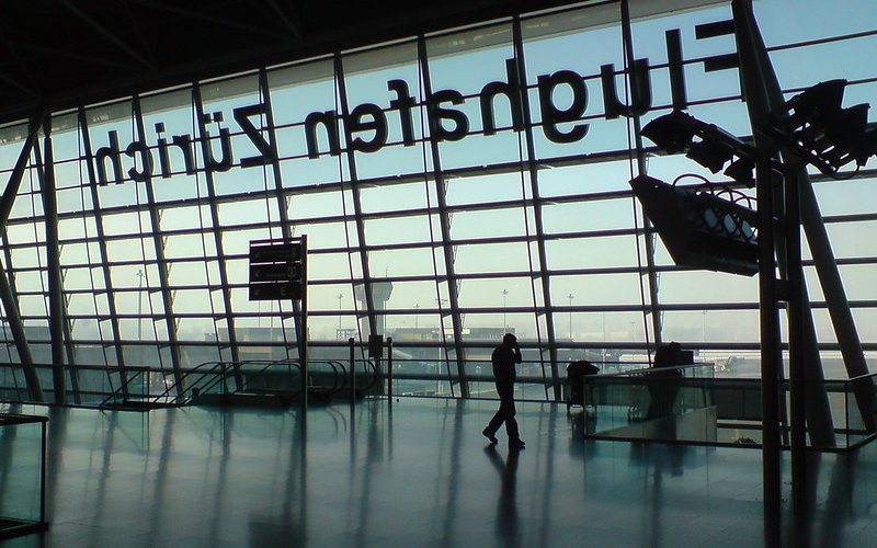 Man walking inside Zurich Airport.