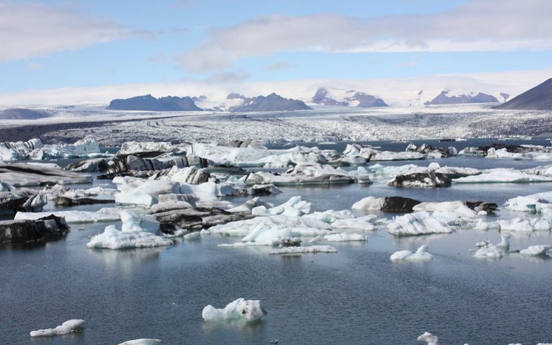 A large glacial lake under clear sky in Iceland.