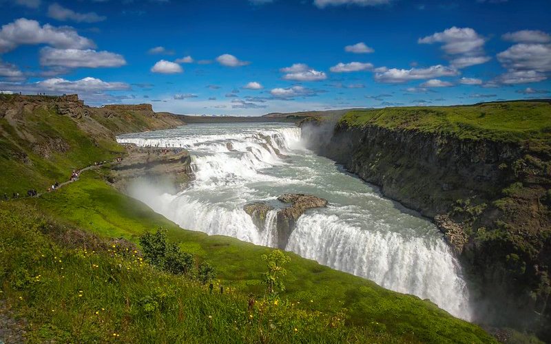 Amazing view of flowing water at Gullfoss Waterfall with greenery all around