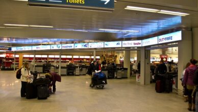 Passengers with their luggage at an airport in Iceland.