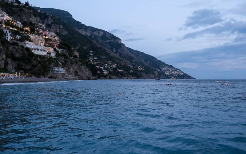 Amafi Coast in Italy with beautiful view of mountains and crystal clear water .