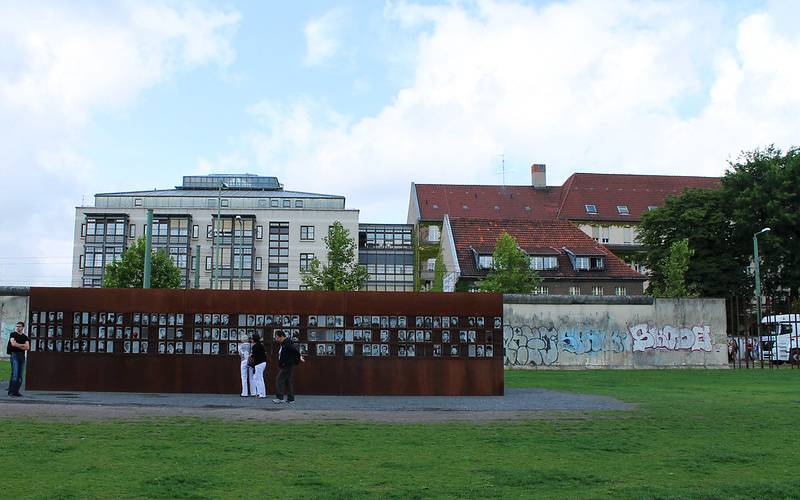 People standing infront of Berlin wall Memorial site