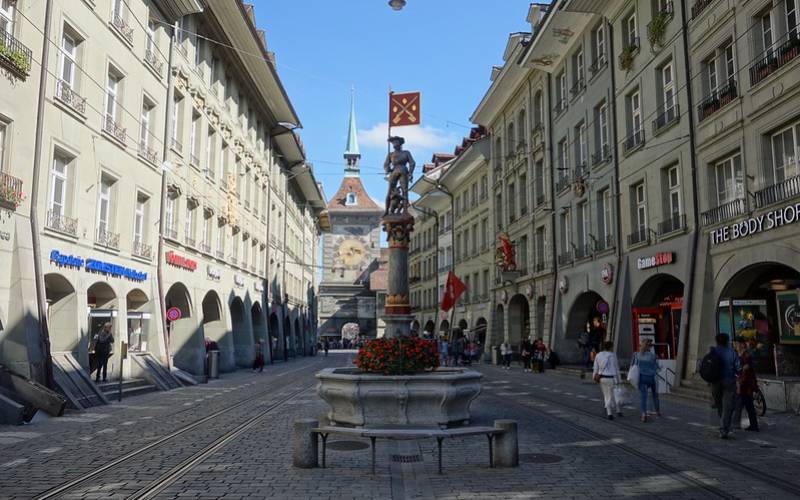 People walking on the streets of Bern during the day time.