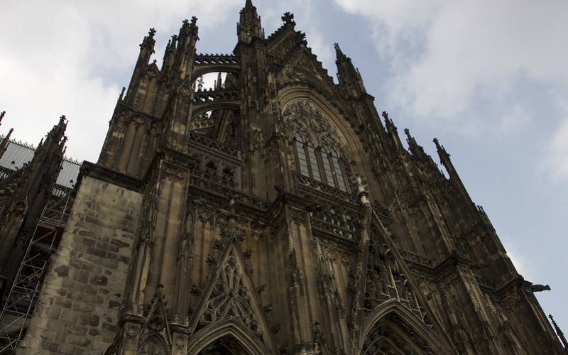 Huge brown concrete building known as Cologne Cathedral in Germany.