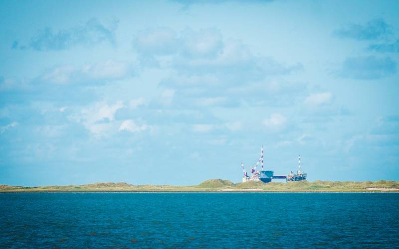 Vast sea with crystal clear water under blue sky known as wadden sea.