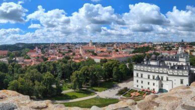 Panoramic view of Lithuania city in Europe under blue and white clouds.