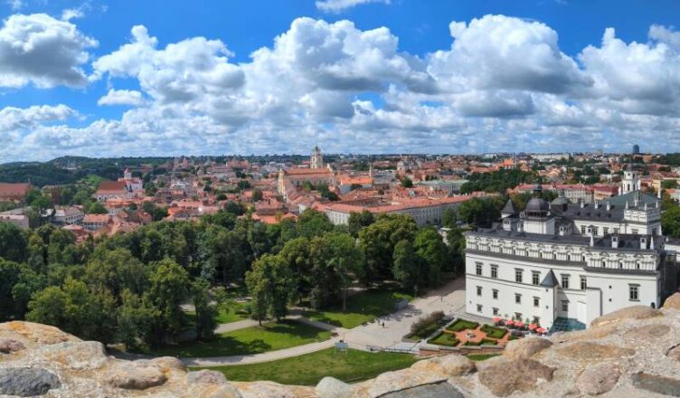 Panoramic view of Lithuania city in Europe under blue and white clouds.