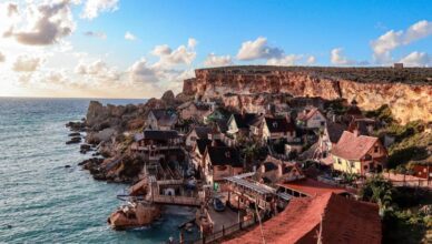 Brown Concrete Buildings Near Body of Water in Malta