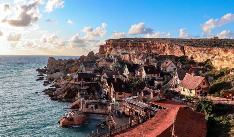 Brown Concrete Buildings Near Body of Water in Malta