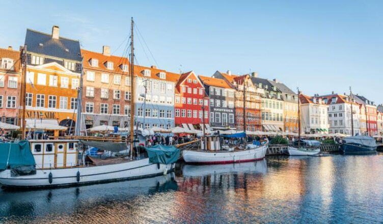 Colorful Nyhavn waterfront in Copenhagen, Denmark with vibrant buildings and boats